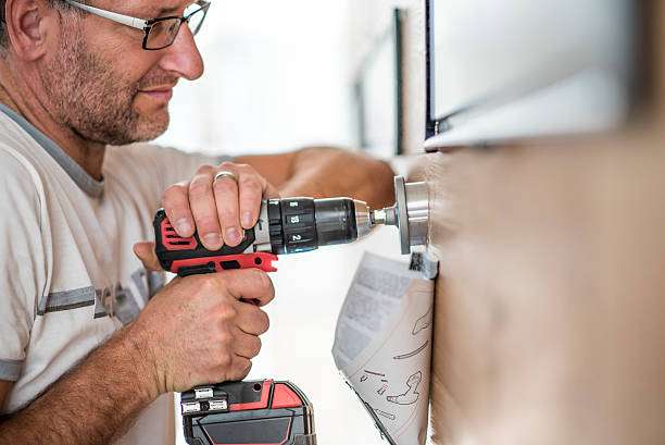 Closeup photo of a handyman drilling a hole