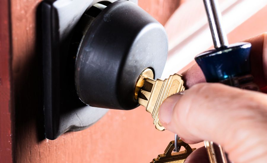 locksmith unlocking door with a key.